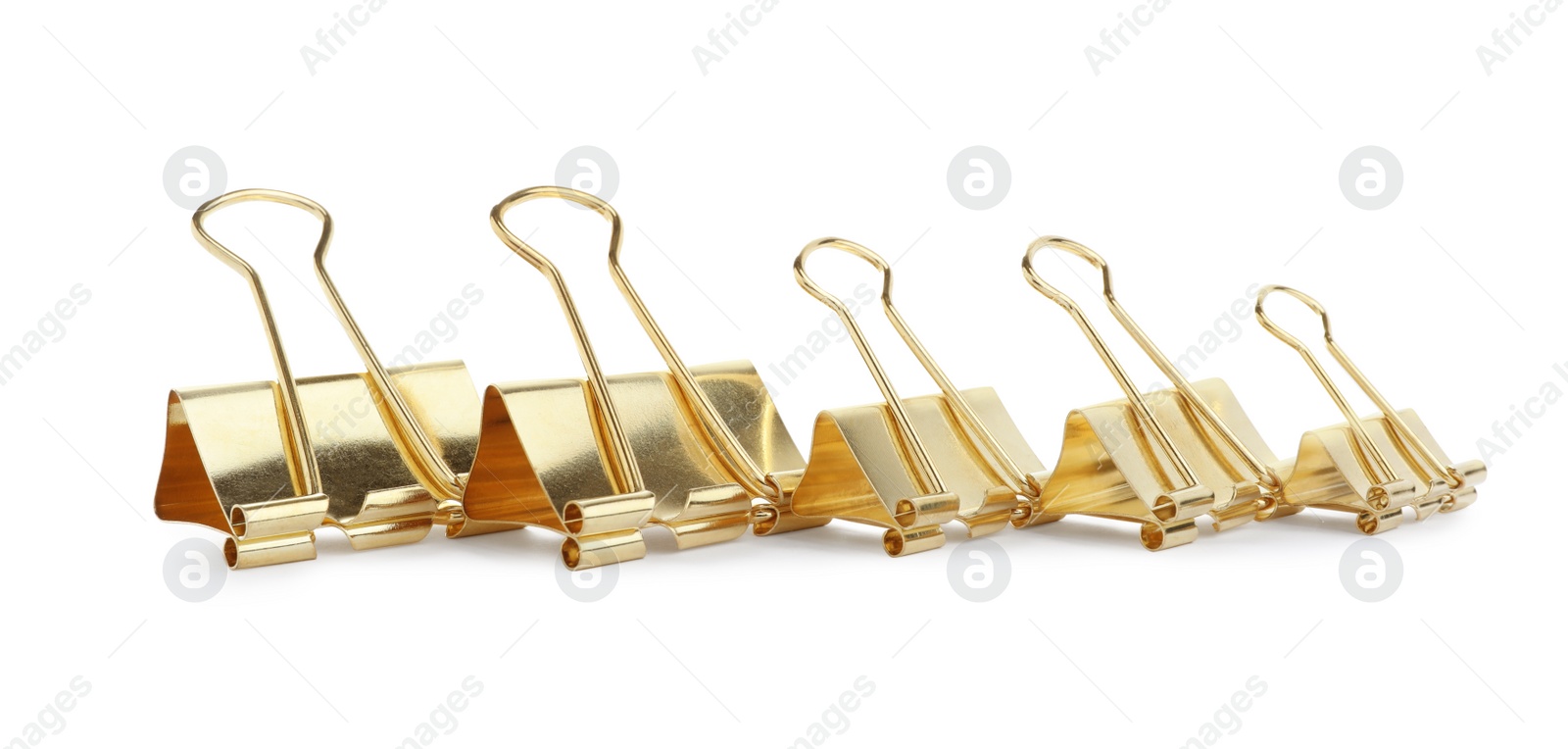 Photo of Golden binder clips on white background. Stationery item