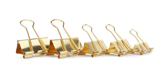 Golden binder clips on white background. Stationery item