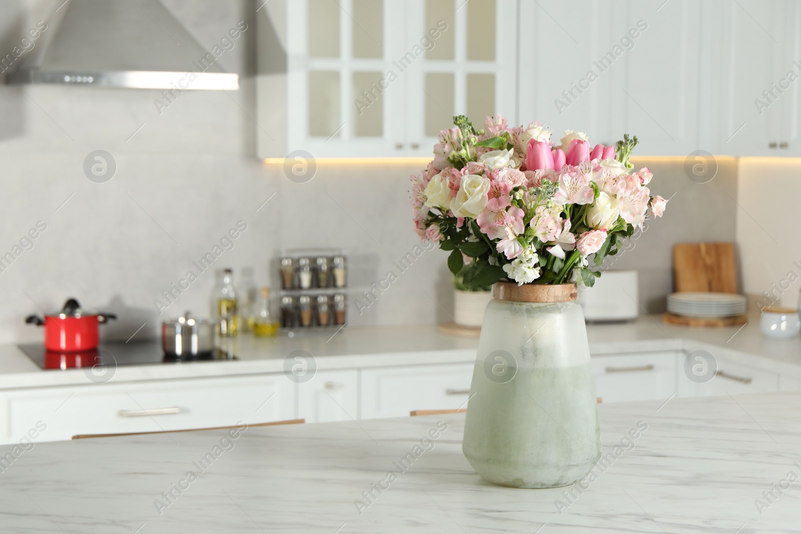 Photo of Beautiful bouquet of fresh flowers in vase on table indoors, space for text
