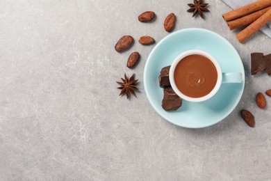 Flat lay composition with yummy hot chocolate on light grey table. Space for text