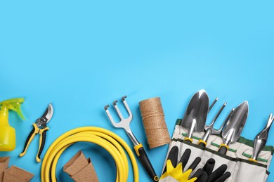 Flat lay composition with gardening tools on light blue background, space for text