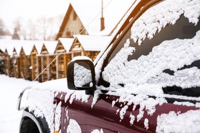 Photo of Car covered with snow after storm outdoors on beautiful winter day, closeup