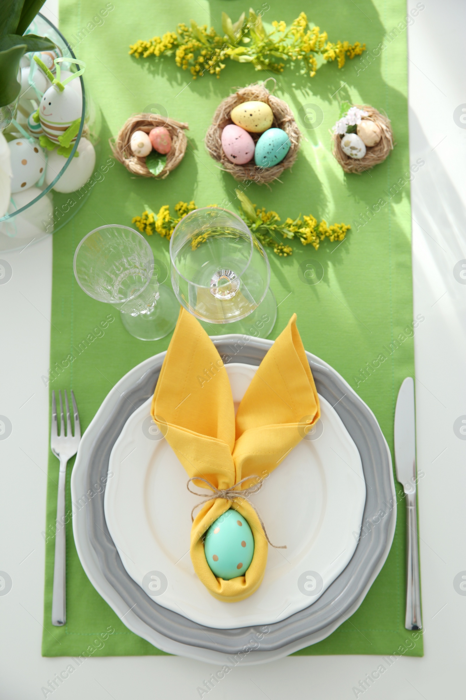 Photo of Festive Easter table setting with beautiful floral decor and eggs, flat lay