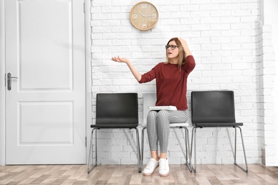 Young woman waiting for job interview, indoors