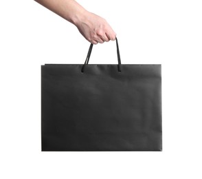 Photo of Woman holding paper shopping bag on white background, closeup