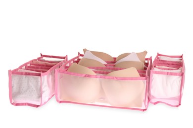 Photo of Transparent organizers with underwear on white background