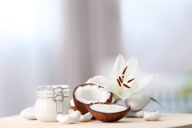 Photo of Composition with coconut butter in glass jar and shell on blurred background