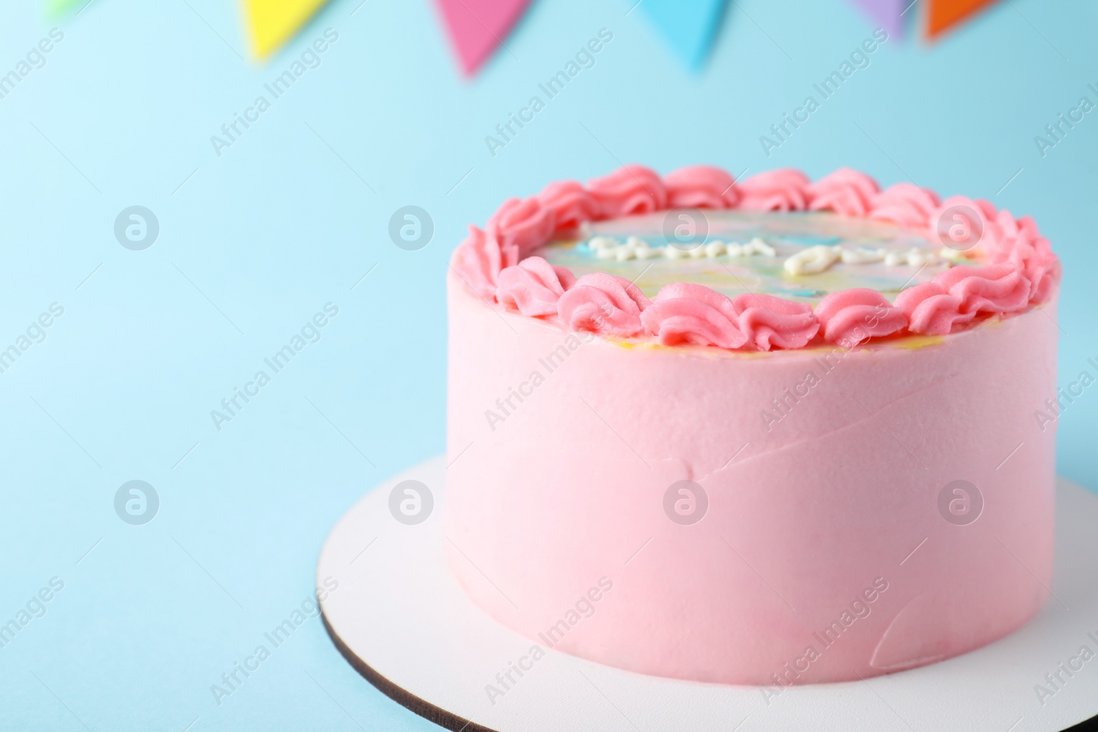 Photo of Cute bento cake with tasty cream on light blue background, closeup. Space for text