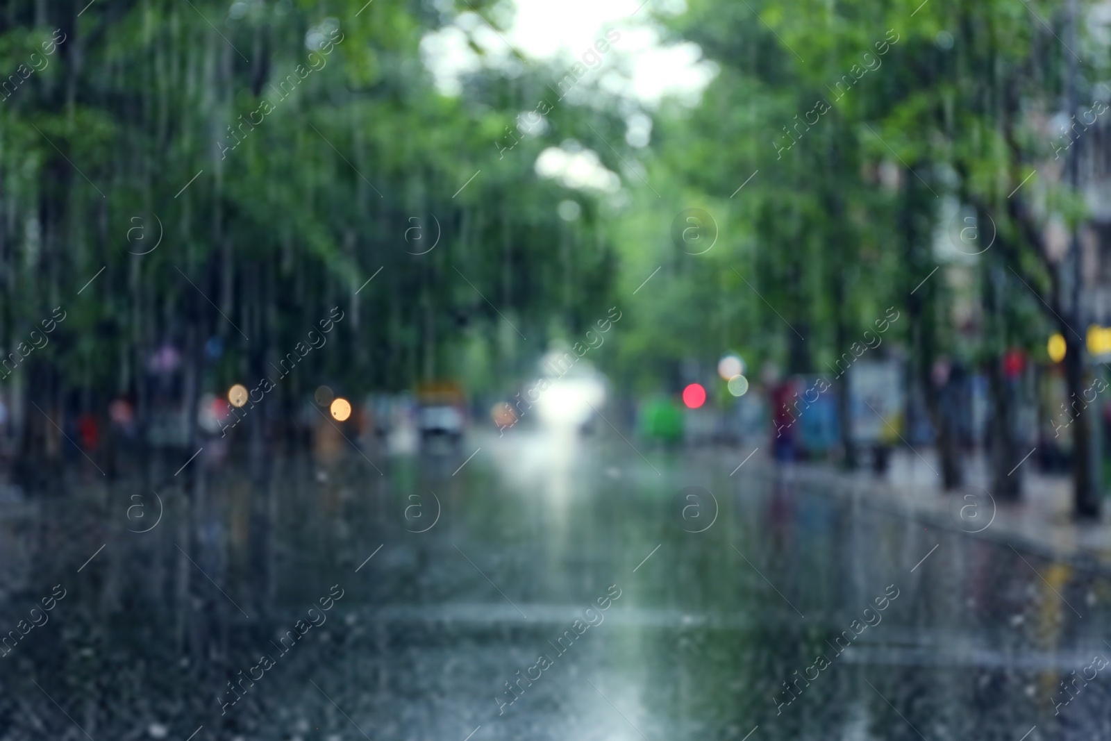 Photo of Blurred view of city street on rainy day