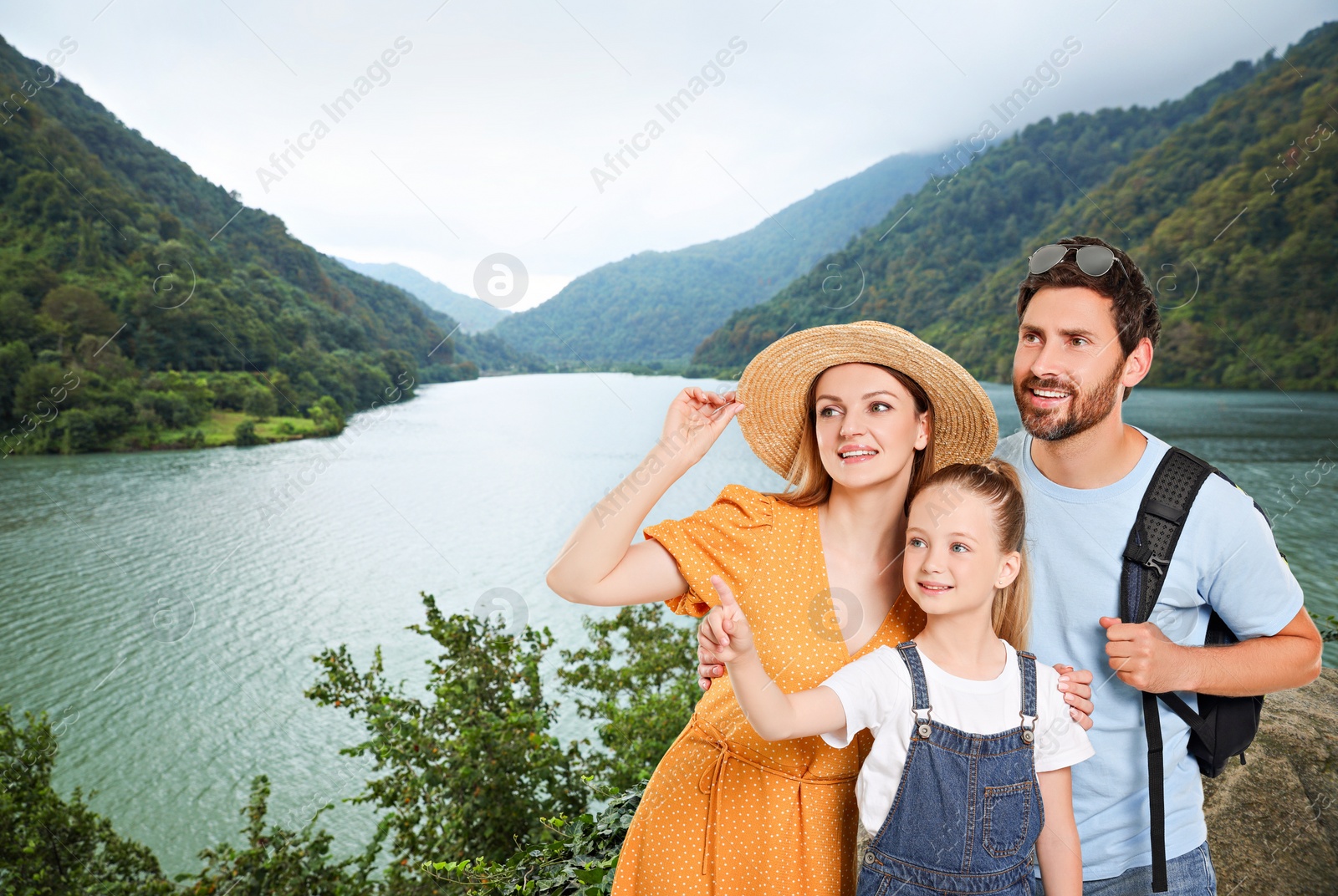 Image of Portrait of happy family with child near palm in mountains