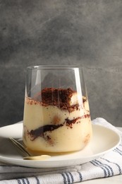 Photo of Delicious tiramisu in glass on white table