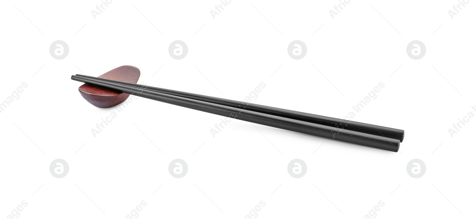 Photo of Pair of black chopsticks with rest isolated on white