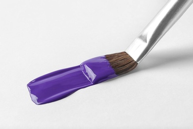 Photo of Brush with color paint and stroke on white background