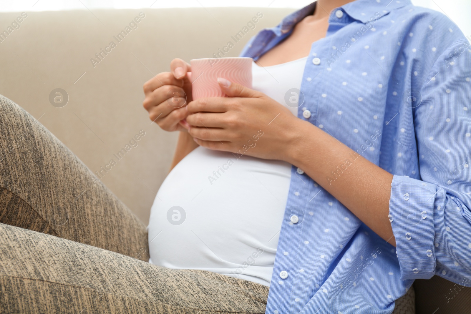 Photo of Pregnant woman drinking tea at home, closeup