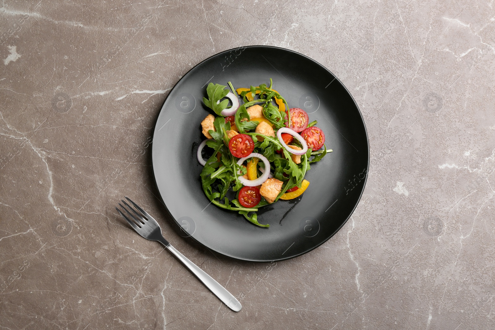 Photo of Delicious fresh chicken salad served on grey table, flat lay