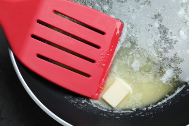 Photo of Melting butter in frying pan, closeup view