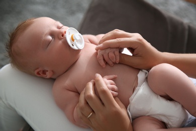 Photo of Mother with her newborn baby, closeup view