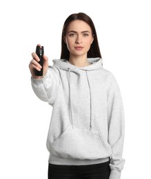 Photo of Young woman using pepper spray on white background