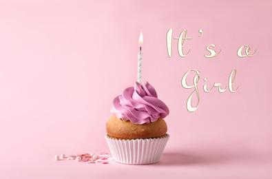 Image of Baby shower cupcake with candle for girl on pink background