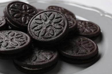 Photo of Many tasty sandwich cookies on plate, closeup