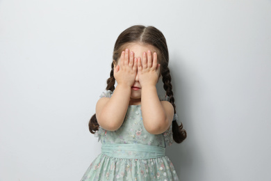 Photo of Cute little girl on light grey background