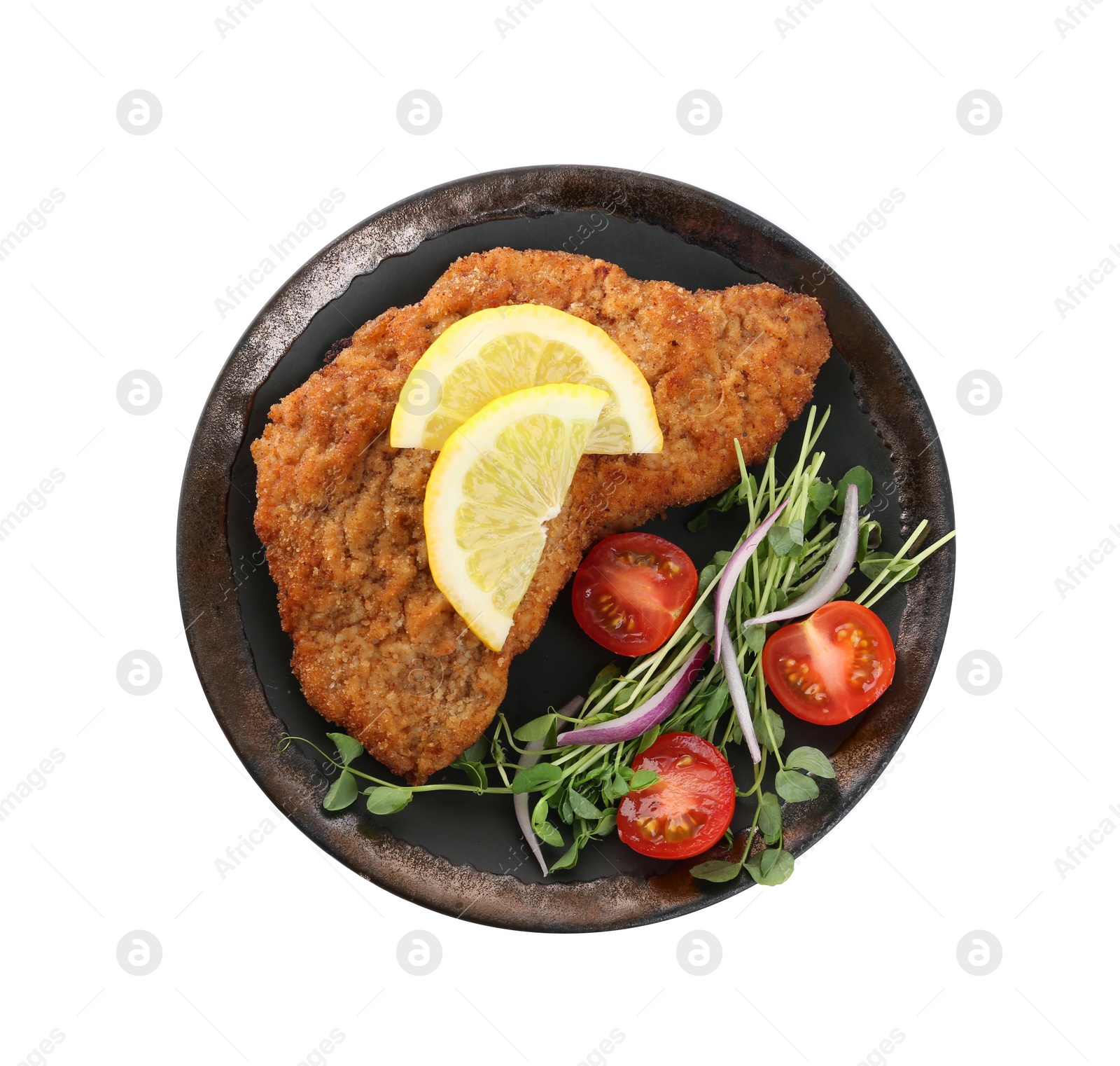 Photo of Plate of delicious schnitzels with lemon, tomatoes, onion and microgreens isolated on white, top view