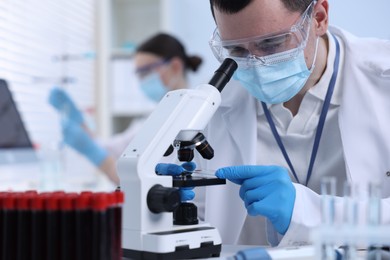 Photo of Scientist working with microscope in laboratory. Medical research