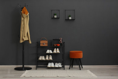 Photo of Hallway interior with stylish furniture, clothes and accessories