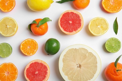 Different citrus fruits on white background, flat lay