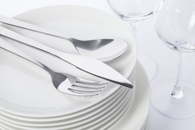 Set of clean tableware on white background, closeup. Washing dishes