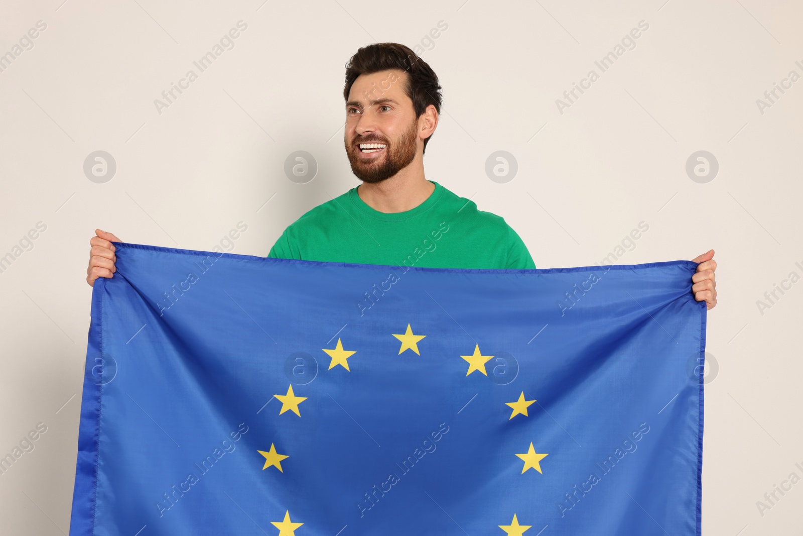 Photo of Man with flag of European Union on white background