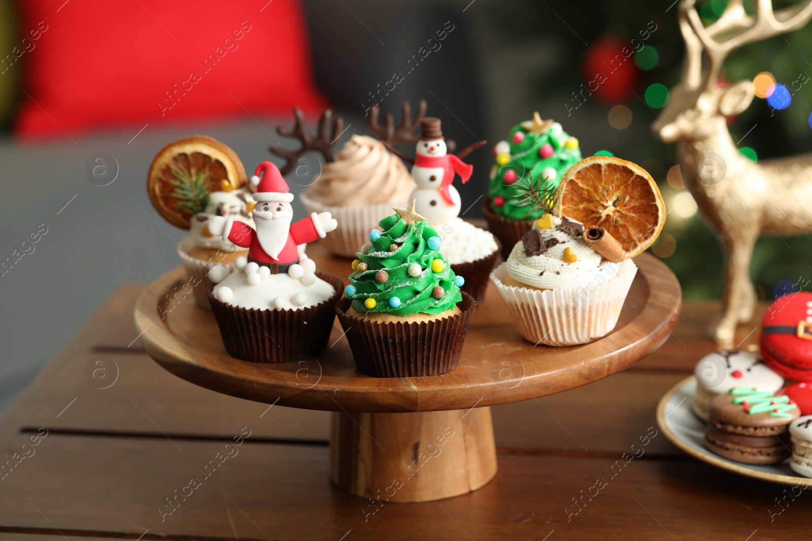 Photo of Many different Christmas cupcakes on wooden table indoors