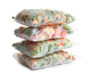 Photo of Frozen vegetables in plastic bags isolated on white