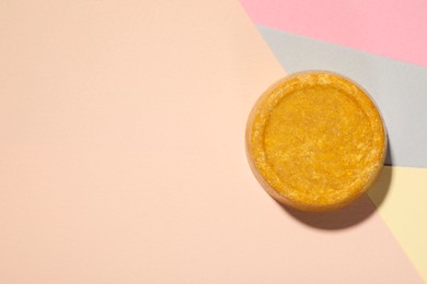 Photo of Orange solid shampoo bar on color background, top view. Space for text