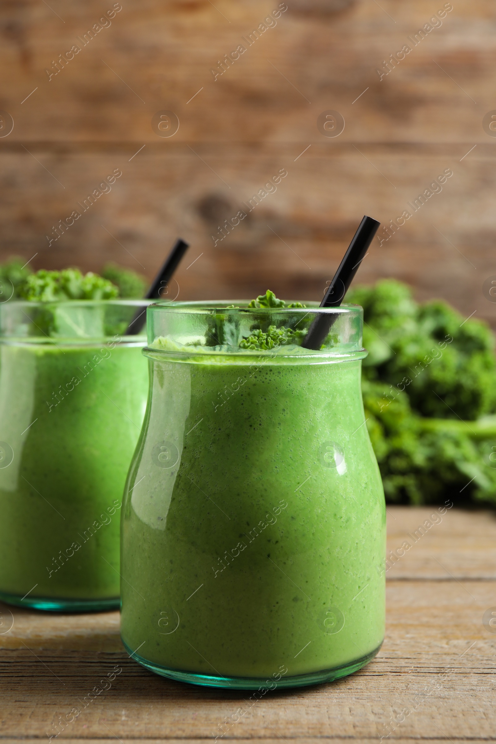 Photo of Tasty fresh kale smoothie on wooden table