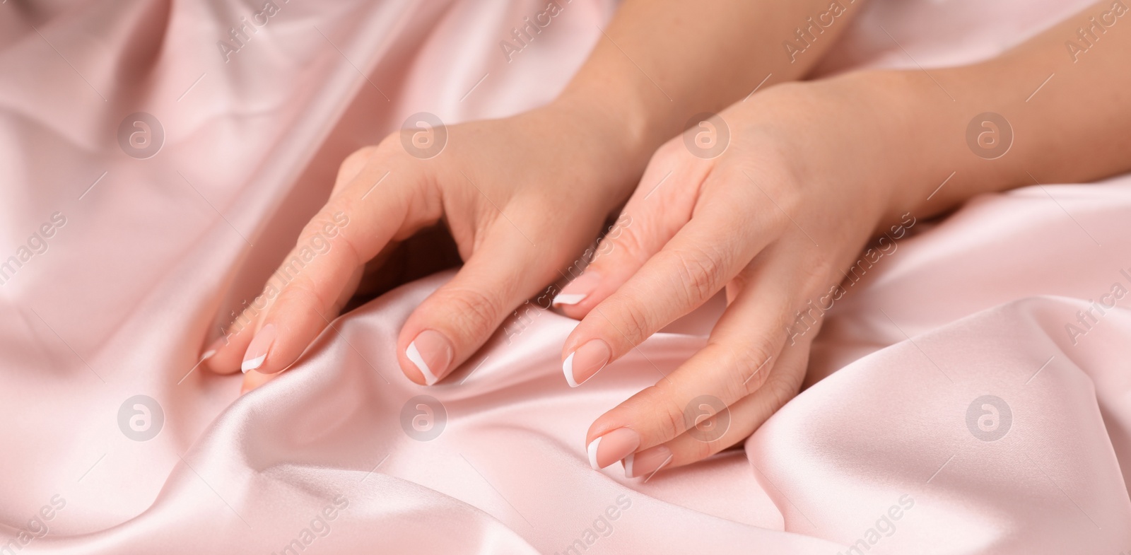 Photo of Woman touching smooth silky fabric, closeup view