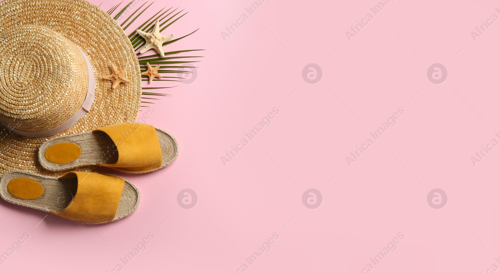 Photo of Beach accessories on pink background, flat lay. Space for text