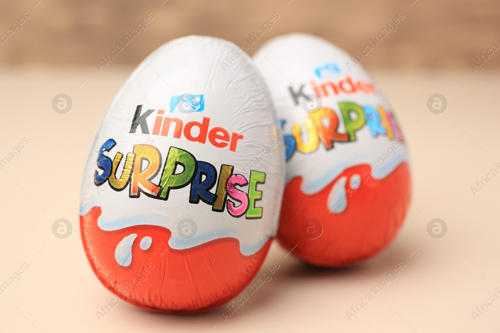 Photo of Slynchev Bryag, Bulgaria - May 25, 2023: Kinder Surprise Eggs on beige background, closeup