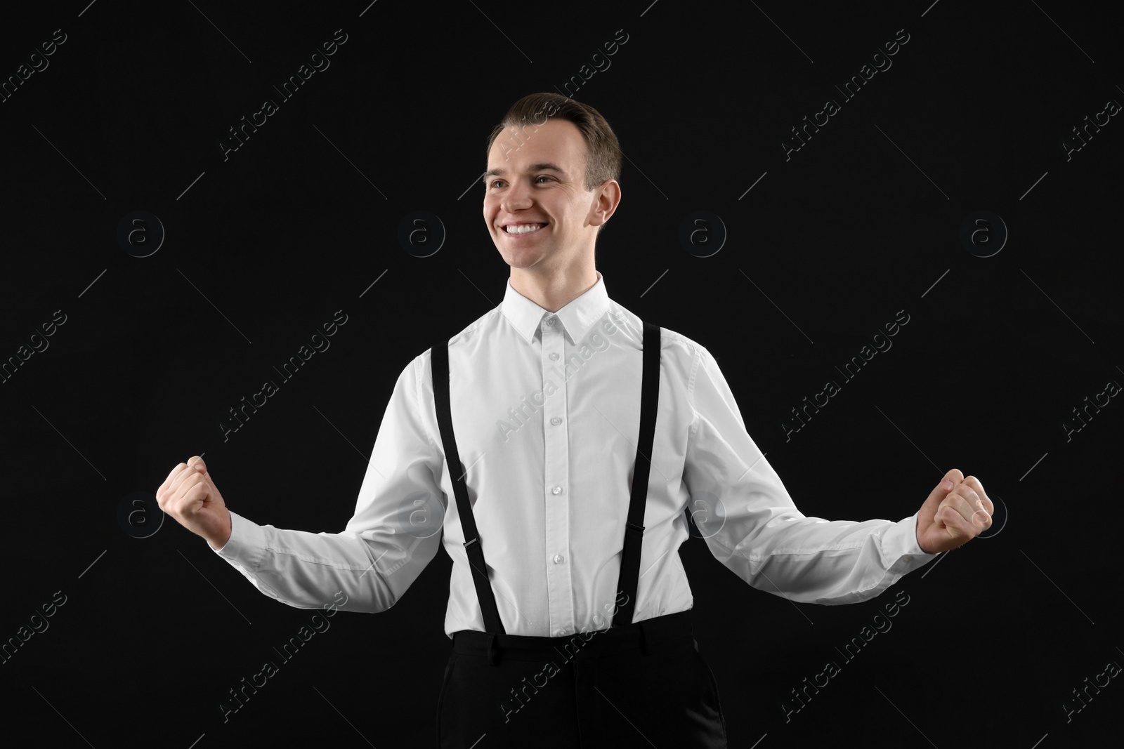 Photo of Cheerful man in white shirt on black background