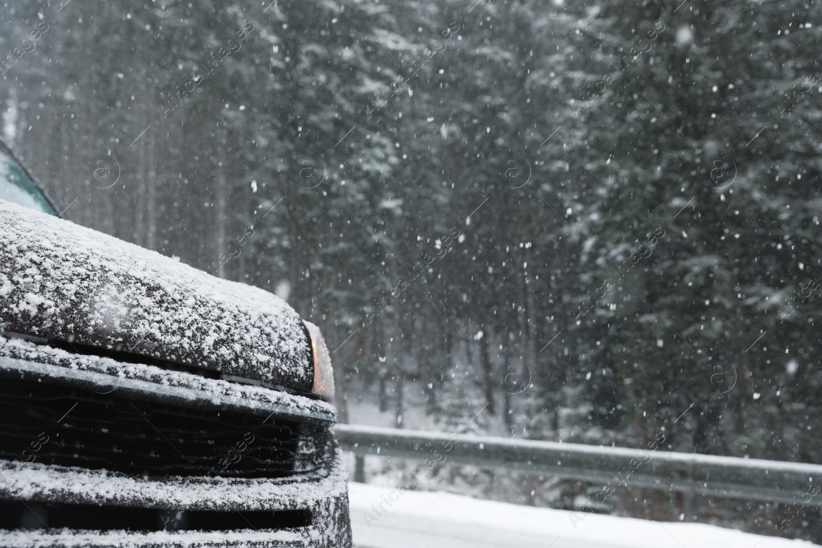 Photo of Car on snowy winter day, closeup view. Space for text