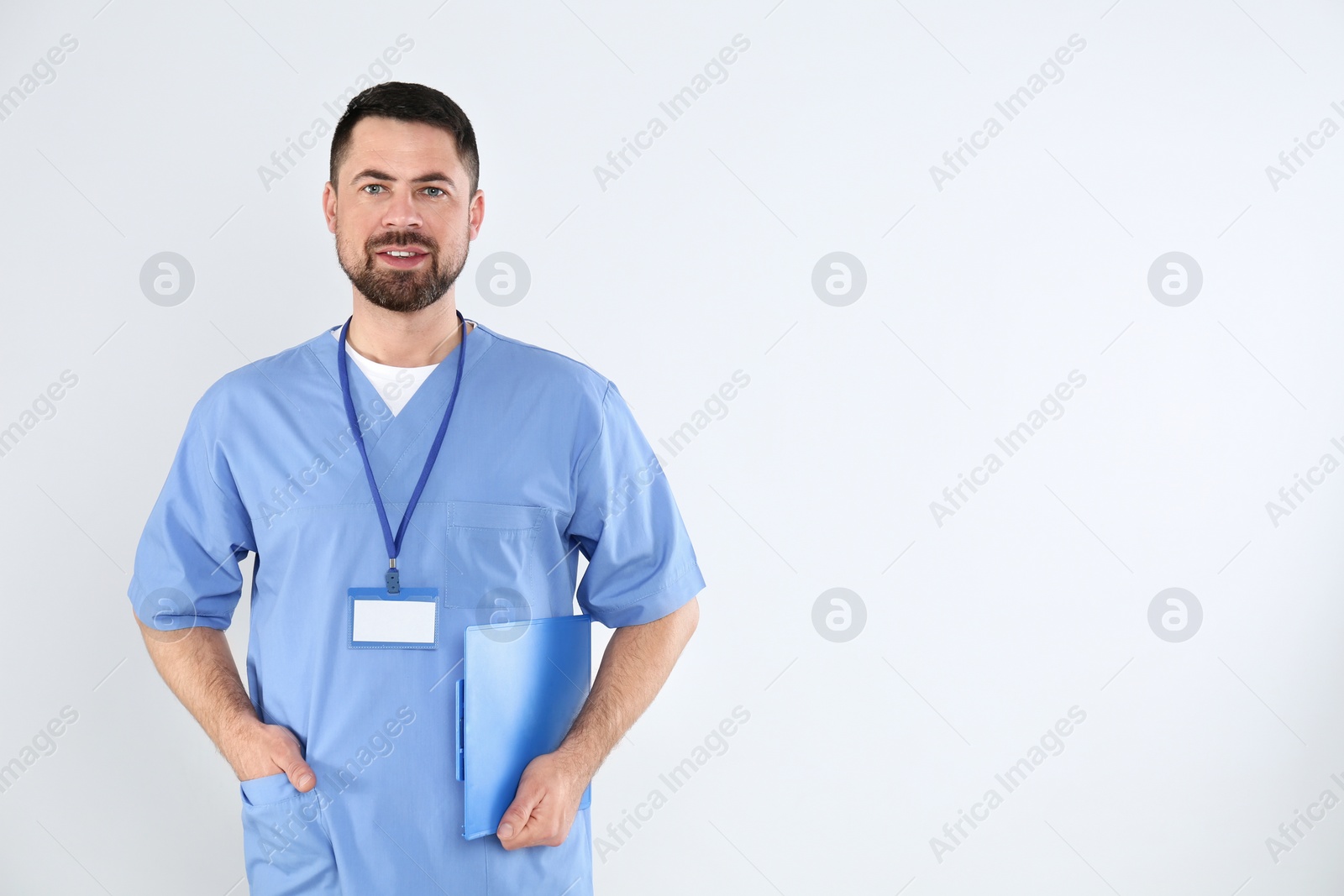 Photo of Portrait of mature doctor with clipboard on white background