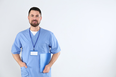 Photo of Portrait of mature doctor with clipboard on white background
