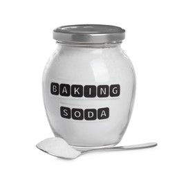 Photo of Spoon and jar with baking soda on white background