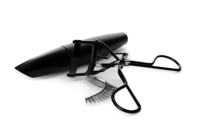 Photo of False eyelashes, curler and mascara on white background