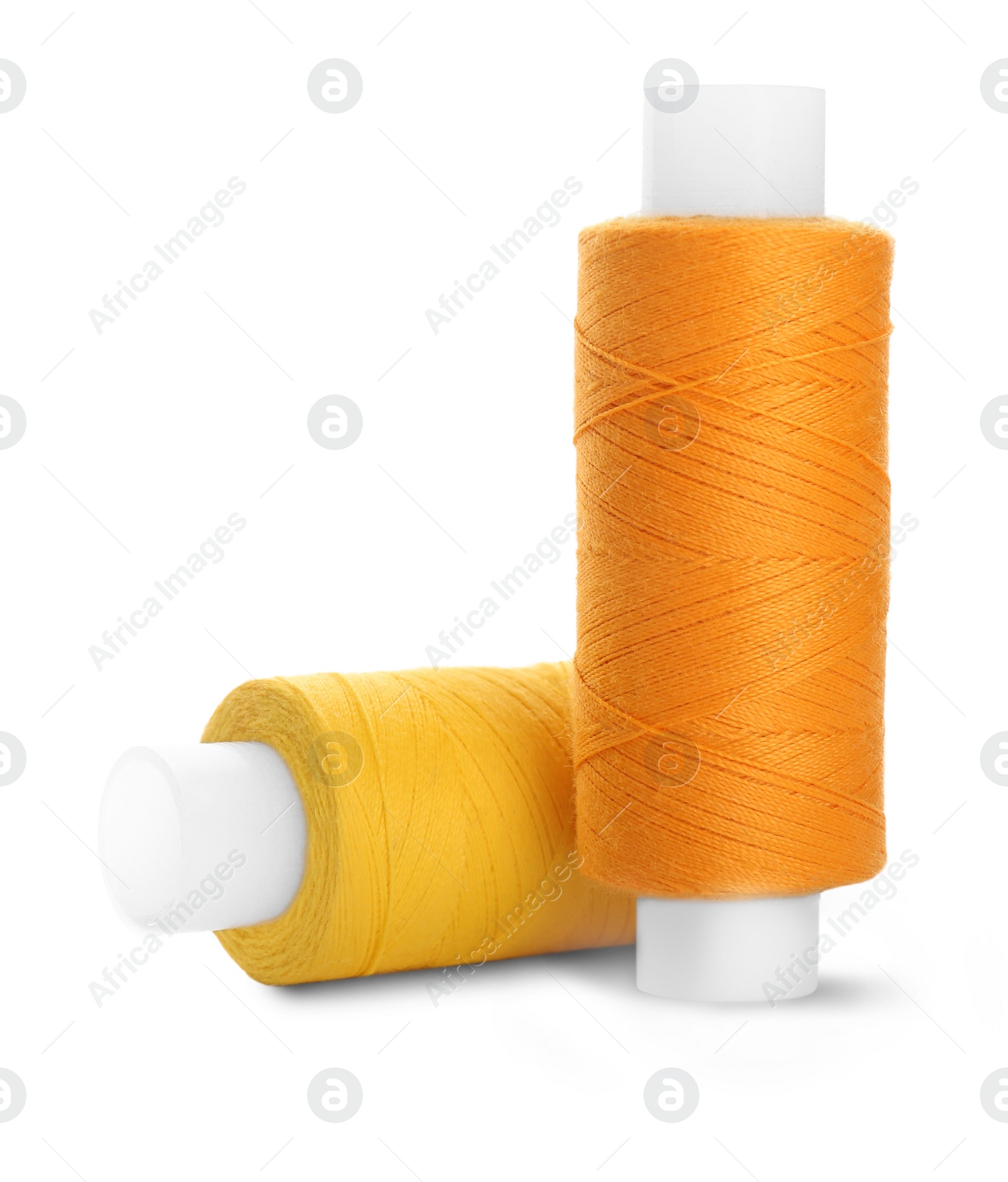 Photo of Different colorful sewing threads on white background