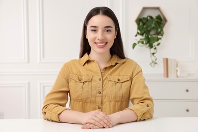 Photo of Beautiful young woman having online video call at home, view from camera