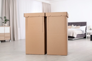 Cardboard wardrobe boxes in bedroom. Storage idea