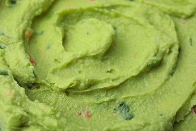 Photo of Delicious guacamole sauce as background, closeup view