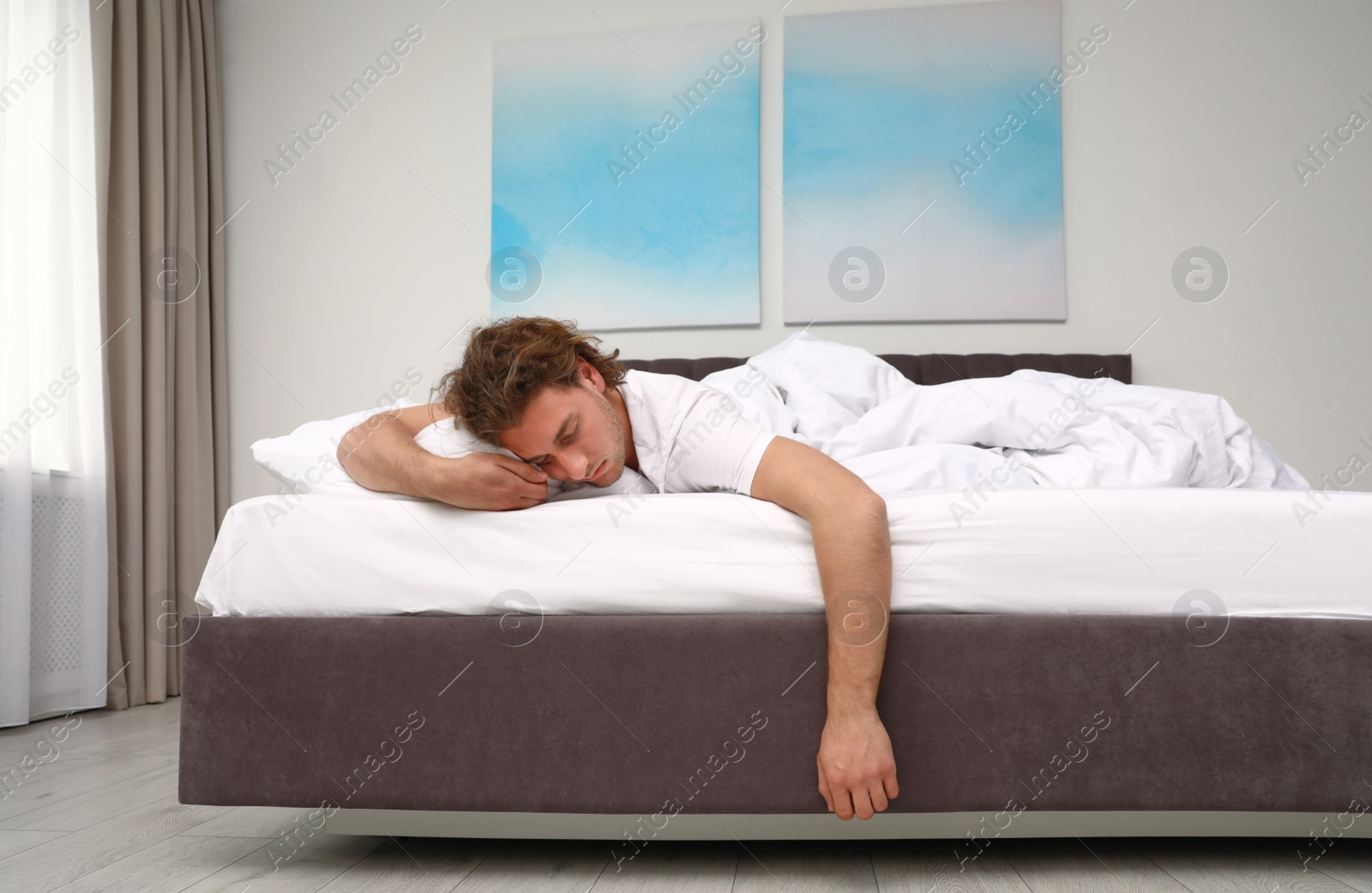 Photo of Handsome young man sleeping on pillow at home. Bedtime