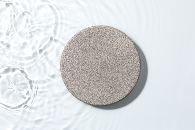 Photo of Presentation for product. Stone podium in water on white background, top view